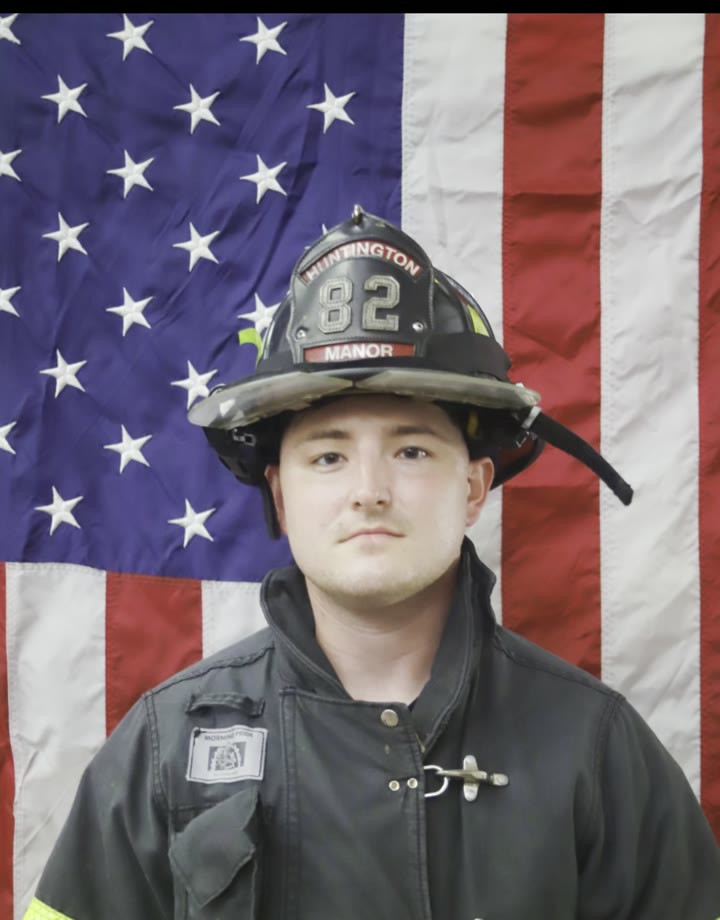 Mason in his Huntington Manor turnout gear, in front of the flag
